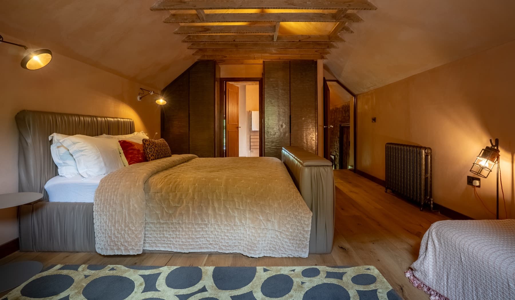 The Render Room, king bed under the plastered roof slope