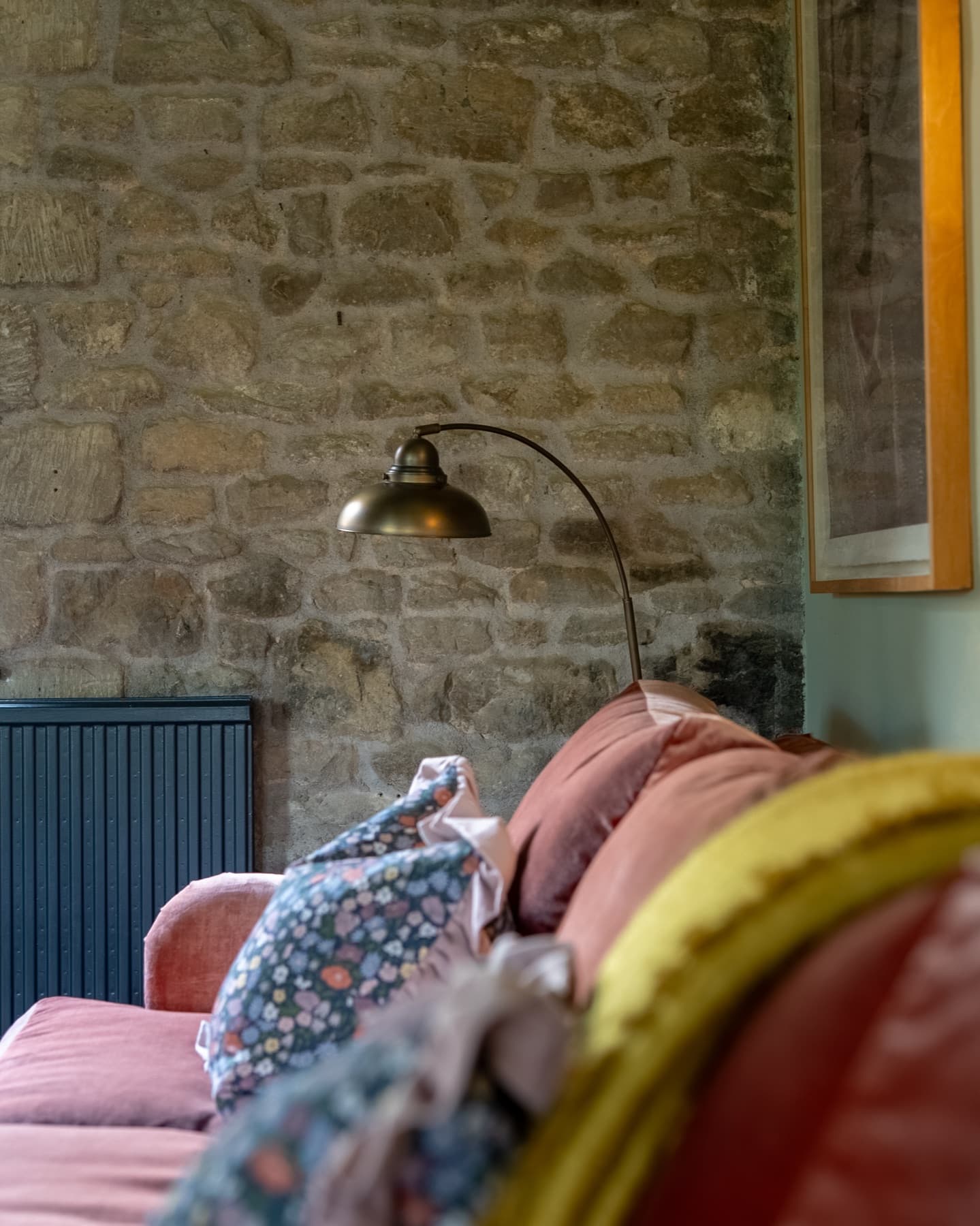 Brass arc lamp against the rubble stone wall