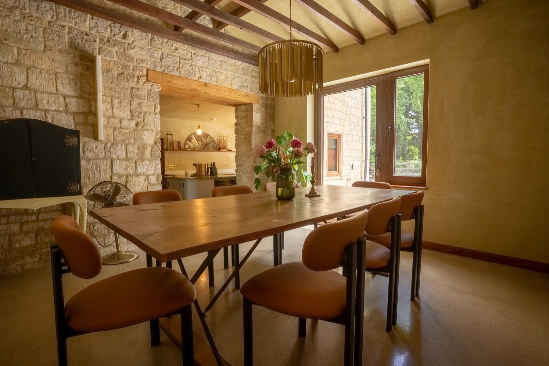 Dining room with the opening through the stone wall to the kitchen