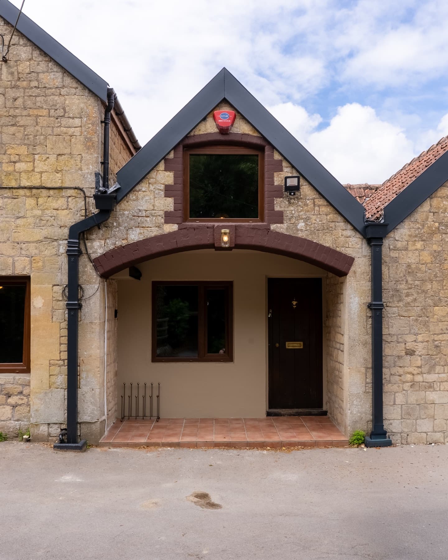 The arched porch and front door of The Old Stables