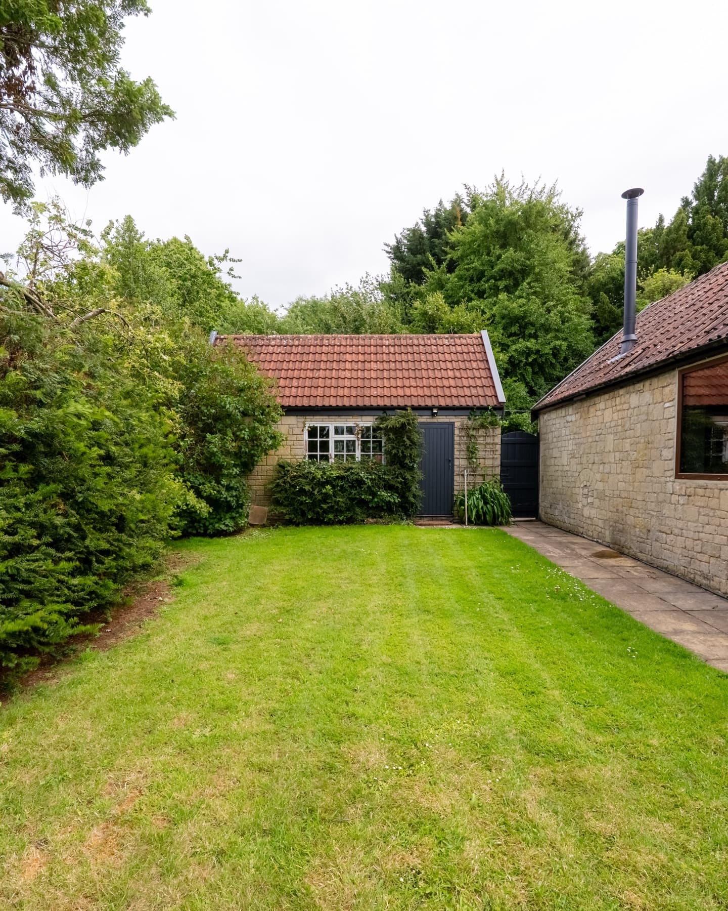 Enclosed lawn between the stone outbuildings
